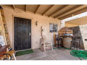 Inviting covered patio area featuring a bar made from a barrel and comfortable seating at 4515 N 26Th Dr, Phoenix, AZ 85017