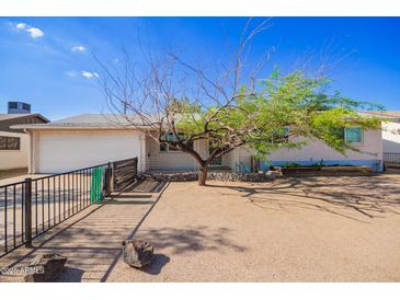 Charming home featuring a well-maintained exterior and a xeriscaped front yard for low-maintenance landscaping at 62 W Beall Ave, Mesa, AZ 85210
