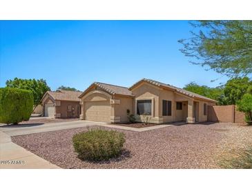 Charming single-story home features a tile roof, two-car garage, and desert landscaping at 10646 E Enid Ave, Mesa, AZ 85208