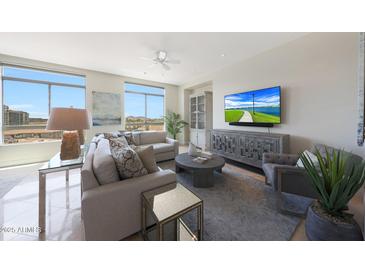 Bright living room features large windows with views and comfortable seating arrangements at 15802 N 71St St # 552, Scottsdale, AZ 85254