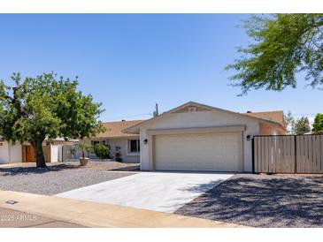 Charming single-story home with a well-manicured front yard and a two-car garage at 4116 W Marshall Ave, Phoenix, AZ 85019