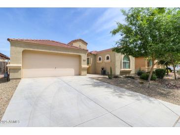 Single Gathering home showcasing desert landscaping, a two car garage, and a neutral color scheme at 41162 W Hayden Dr, Maricopa, AZ 85138