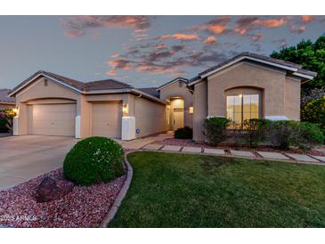 Charming single-story home featuring a well-manicured lawn, two-car garage, and inviting entrance at 4215 W Hackamore Dr, Phoenix, AZ 85083