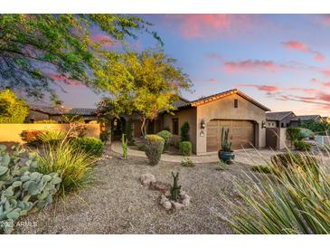 Charming desert home with a well-manicured front yard, mature trees, and a two-car garage at 8139 E Club Village Dr, Gold Canyon, AZ 85118