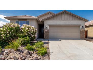 Charming single-Gathering home featuring a two-car garage and low-maintenance desert landscaping at 9822 W Caron Dr, Peoria, AZ 85345
