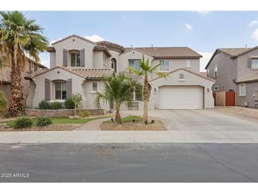 Charming two-story home boasts a well-manicured front yard, desert landscaping, and an attached two-car garage at 11142 E Ravenna Ave, Mesa, AZ 85212