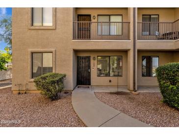 Charming condo featuring a private entrance, balcony, and well-maintained desert landscaping at 13636 N Saguaro Blvd # 103, Fountain Hills, AZ 85268