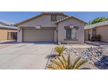 Charming single-story home with a two-car garage and desert landscaping at 15905 W Saguaro Ln, Surprise, AZ 85374