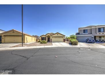 Charming single-Gathering home with desert landscaping, paved driveway and well-maintained lawn at 24035 W La Salle St, Buckeye, AZ 85326
