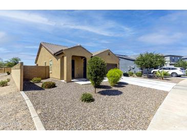 Inviting single-story home featuring desert landscaping, a private drive, and a neutral color scheme at 2430 E Alonso Dr, Casa Grande, AZ 85194
