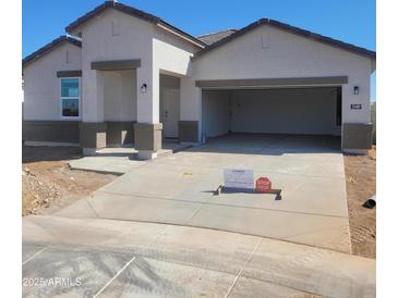 Charming single-story home featuring a spacious two-car garage and modern architectural details at 25489 W Fraktur Rd Rd, Buckeye, AZ 85326