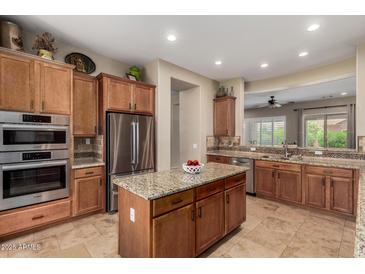 Modern kitchen features stainless steel appliances, granite countertops, and ample cabinet space at 2554 E Honeysuckle Pl, Chandler, AZ 85286