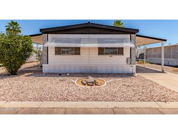 Charming mobile home with rock detail in the front yard and an awning covering the windows at 2650 W Union Hills Dr # 269, Phoenix, AZ 85027