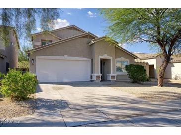 Charming one-story home featuring a stucco exterior, attached garage, and well-maintained landscaping in a desirable neighborhood at 2676 E Mineral Park Rd, San Tan Valley, AZ 85143