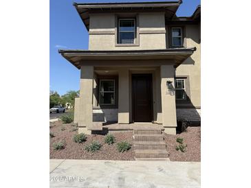 Charming front entrance with brick steps and well-maintained landscaping, enhancing curb appeal at 2815 N Claire Dr, Buckeye, AZ 85396