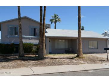 Charming two-story home with a well-maintained yard and mature trees at 4550 W Cinnabar Ave, Glendale, AZ 85302
