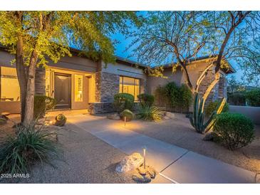 Inviting front yard featuring desert landscaping and a charming walkway leading to the home's entrance at 6069 E Ironwood Dr, Scottsdale, AZ 85266