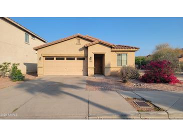 Charming single-story home with a low-maintenance landscaped front yard and attached two-car garage at 6820 S 68Th Ln, Laveen, AZ 85339