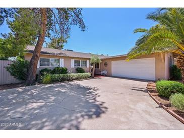 Charming single story home with a two car garage and shade trees in the front yard at 8637 E Solano Dr, Scottsdale, AZ 85250
