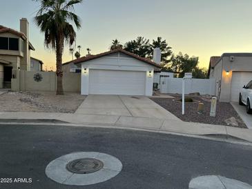 Charming single-story home featuring a desert-landscaped front yard and attached two-car garage at 1044 N Arvada N --, Mesa, AZ 85205
