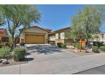 Charming single-Gathering home with a two-car garage and lush desert landscaping at 18108 W Thunderhill Pl, Goodyear, AZ 85338