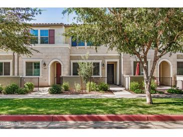 Inviting townhouse with well-maintained landscaping, enhancing curb appeal at 1825 E Hampton Ln # 108, Gilbert, AZ 85295
