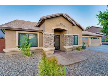 Charming single-story home with stone accents, desert landscaping and a welcoming entrance at 1849 S 96Th St, Mesa, AZ 85209