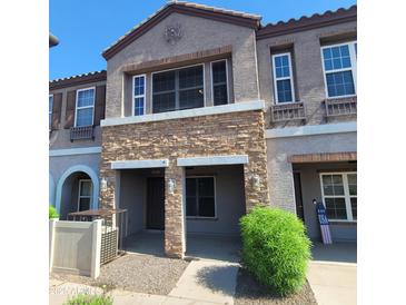 Charming two-story townhome with stone accents and well-maintained landscaping in a desirable neighborhood at 2323 E Huntington Dr, Phoenix, AZ 85040
