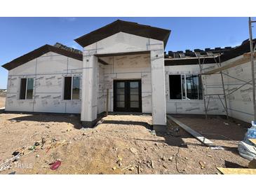 Exterior construction of home with a modern entrance featuring dark double doors at 37459 W Missouri Ave, Tonopah, AZ 85354