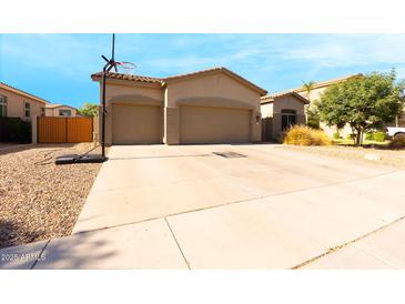Charming single-story home featuring a spacious driveway and a two-car garage at 4064 E Reins Rd, Gilbert, AZ 85297