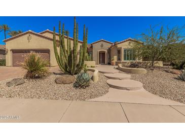 Charming single-story home featuring desert landscaping and a welcoming walkway to the front door at 16704 W Oracle Rim Dr, Surprise, AZ 85387