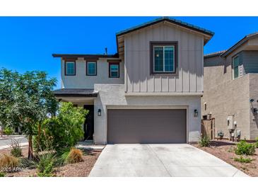 Charming two-story home featuring a two-car garage, landscaped yard, and a mix of modern and traditional architectural styles at 1914 N Marketside Ave, Buckeye, AZ 85396