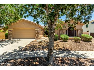 Charming home featuring a desert landscape, stone accents, and a two-car garage with ample parking space at 3715 S Skyline Dr, Gilbert, AZ 85297