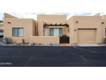 Charming tan stucco home features a private courtyard and attached one car garage at 37222 N Tom Darlington Dr # 15, Carefree, AZ 85377