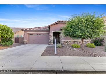 Charming single-story home featuring a low-maintenance landscaped front yard and an attached two-car garage at 3865 E Dogwood Pl, Chandler, AZ 85286