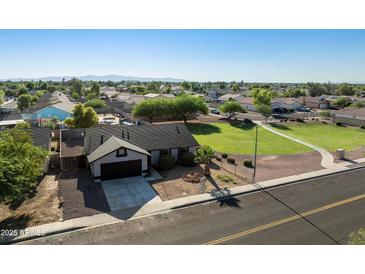 Charming single-story home featuring well-kept landscaping and a convenient attached garage at 5602 N 73Rd Ave, Glendale, AZ 85303