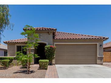 Charming single-story home with a well-manicured front yard and a neutral color scheme at 5659 N 195Th Dr, Litchfield Park, AZ 85340