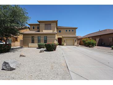 Two-story home featuring desert landscaping, tile roof, and a long driveway leading to a two-car garage at 3088 E Andre Ave, Gilbert, AZ 85298