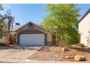 Charming single-story home featuring a two-car garage and a well-maintained, low-maintenance front yard at 3755 E Broadway Rd # 36, Mesa, AZ 85206