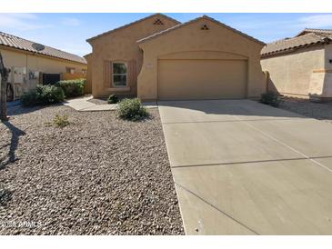Inviting single-story home featuring a neutral exterior, low-maintenance landscaping, and an attached two-car garage at 5339 W Maldonado Rd, Laveen, AZ 85339