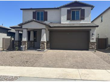 Charming two-story home featuring a brick-paved driveway and a welcoming front porch at 804 W Lark Dr, Queen Creek, AZ 85140