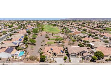 Expansive aerial view of a golf community featuring desert landscaping and homes with solar panels at 20655 N 273Rd Ave, Buckeye, AZ 85396