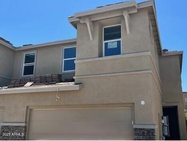 Inviting exterior of a two-story home with a neutral color scheme, stone accents, and a convenient garage at 21228 N 58Th St, Phoenix, AZ 85054