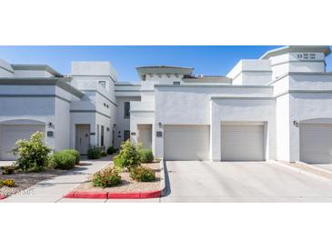 Inviting exterior view of a two-story home with a well-maintained lawn and attached garage at 295 N Rural Rd # 143, Chandler, AZ 85226