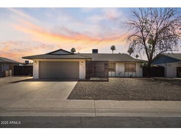 Inviting single-story home with a two-car garage, enhanced by a beautiful sunset backdrop at 4415 S Poplar St, Tempe, AZ 85282