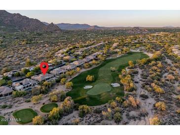 Stunning aerial view of property on the golf course with mountain views at 6481 E Amber Sun Dr, Scottsdale, AZ 85266