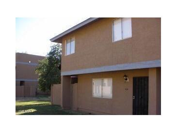 Modest two-story exterior with a quaint front lawn and views from the upper-level windows at 6911 W Devonshire Ave # 1269, Phoenix, AZ 85033