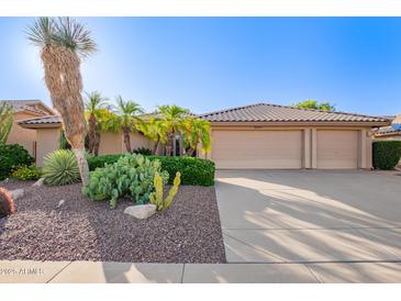 Beautiful home with desert landscaping, mature palm trees, and a three-car garage at 8402 W Rosemonte Dr, Peoria, AZ 85382