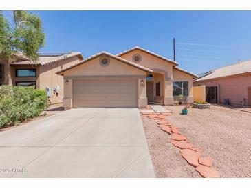 Charming single-story home with desert landscaping, two-car garage and covered entryway at 8622 W Shaw Butte Dr, Peoria, AZ 85345