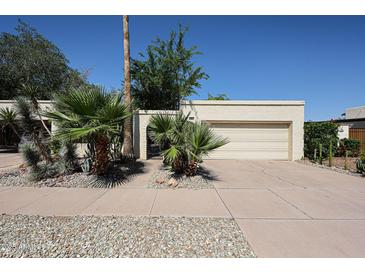 Charming home featuring a two-car garage, desert landscaping, and a gated front entrance at 1500 N Markdale -- # 68, Mesa, AZ 85201